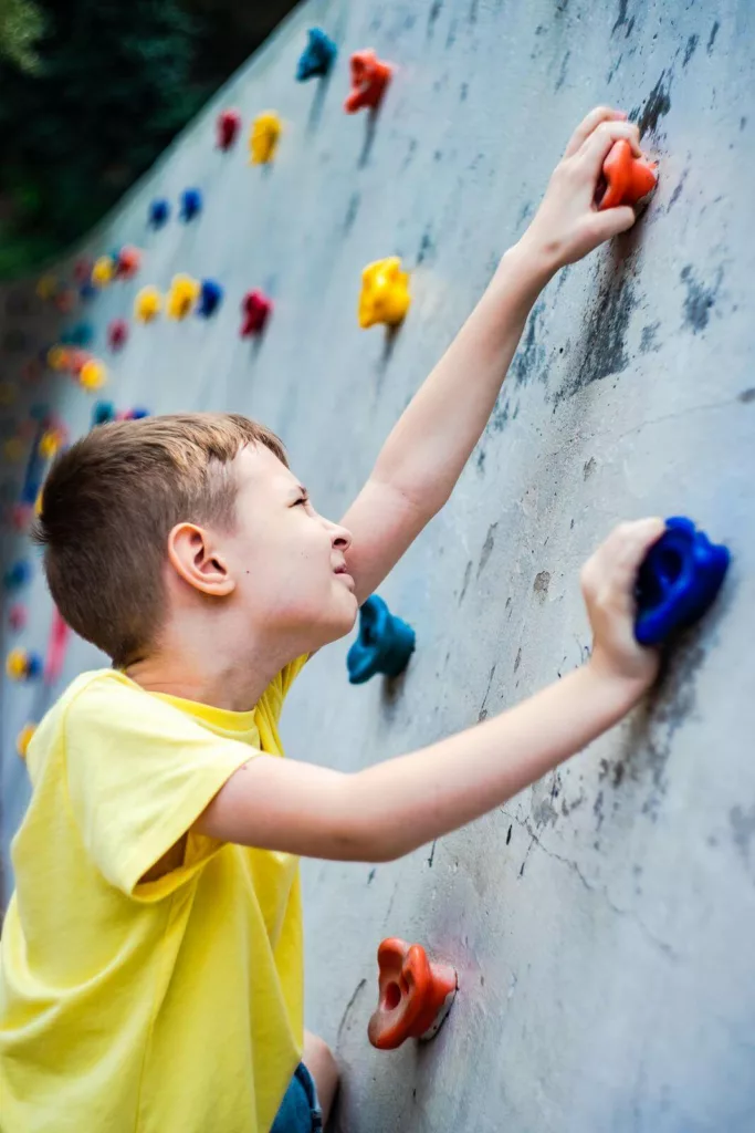ילד מטפס על קיר בחוץ